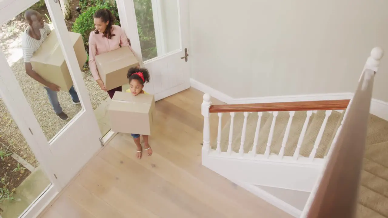 African American couple and their daughter moving into new house