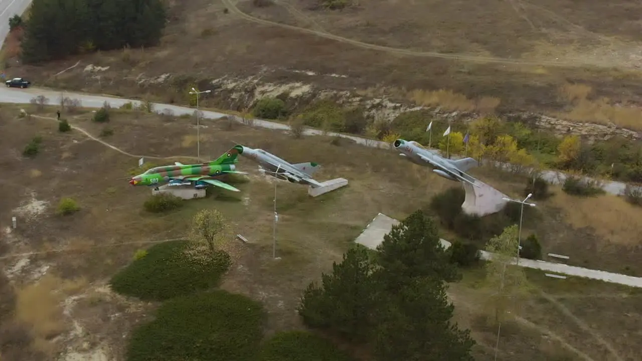 Aerial panning footage of military airplanes outdoor museum exhibition-3