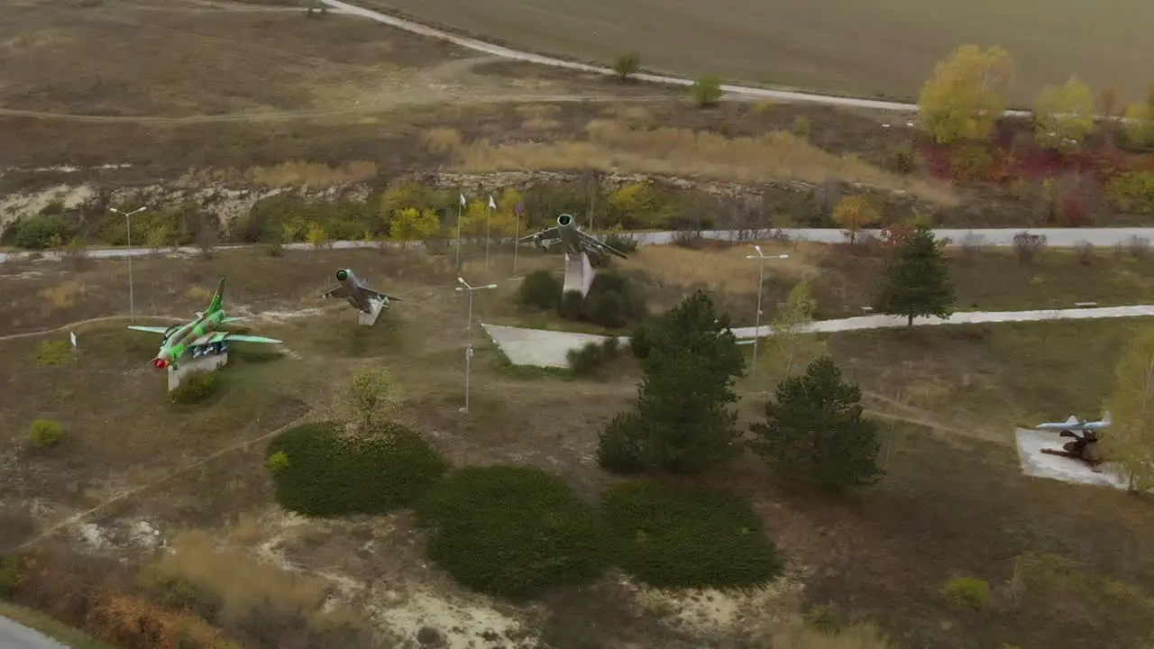 Aerial panning footage of military airplanes outdoor museum exhibition-2