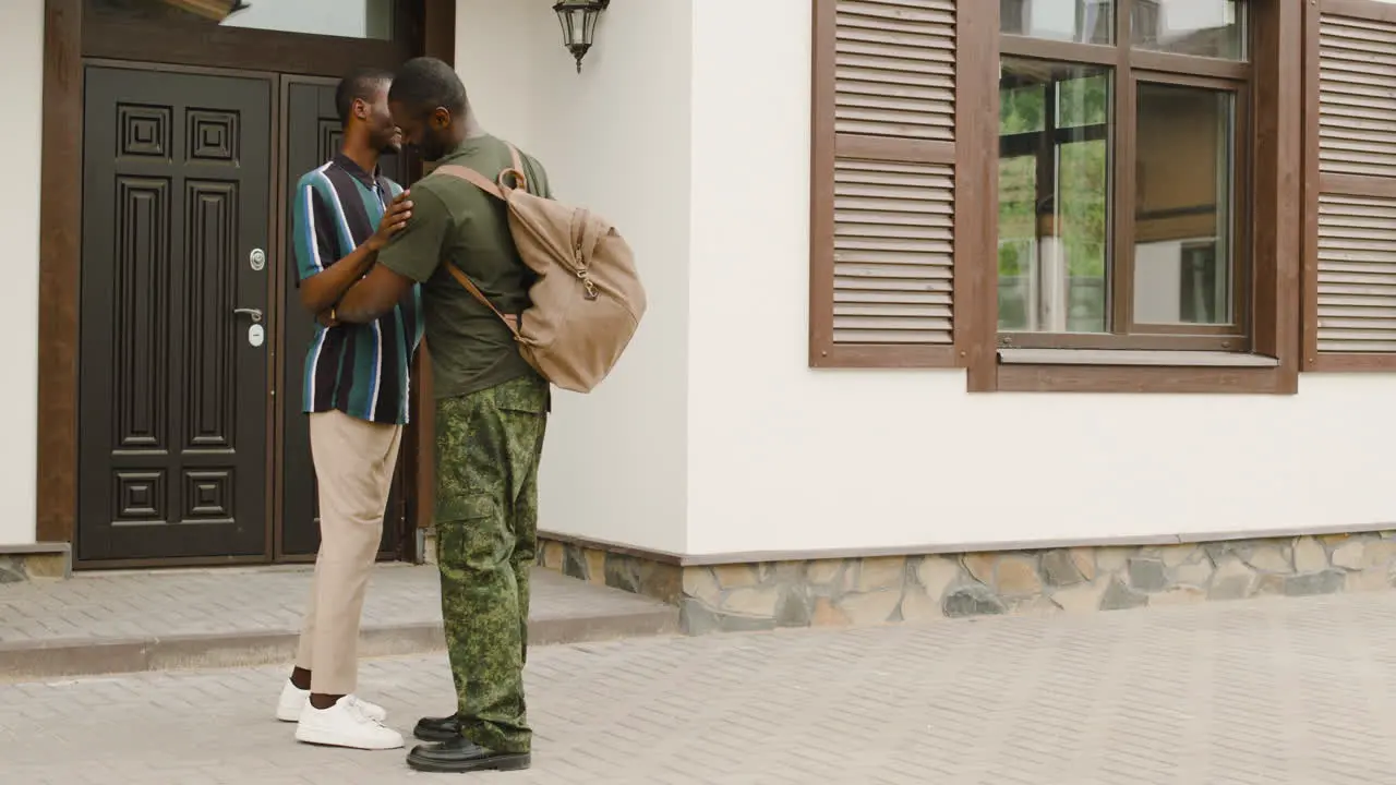 Male Soldier Hugging And Saying Goodbye To His Son Outside Home Before Going To Military Service 2