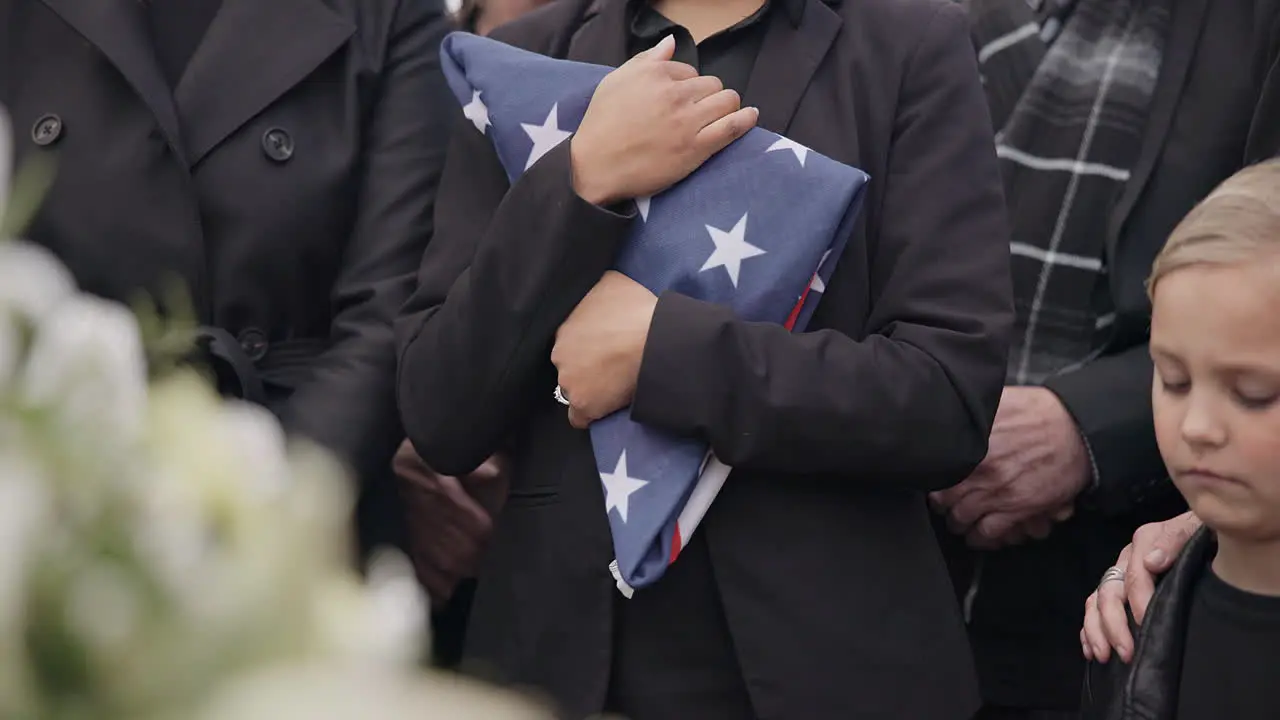 Funeral cemetery and woman with American flag