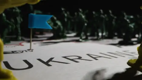 Tracking Shot Over Toy Soldiers On Map of Ukraine 10