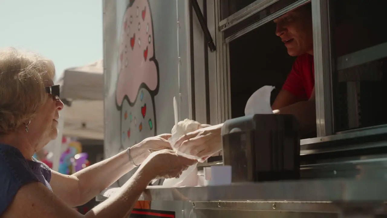 Middle-Aged woman buying ice cream bowl from street vendor Slow Motion