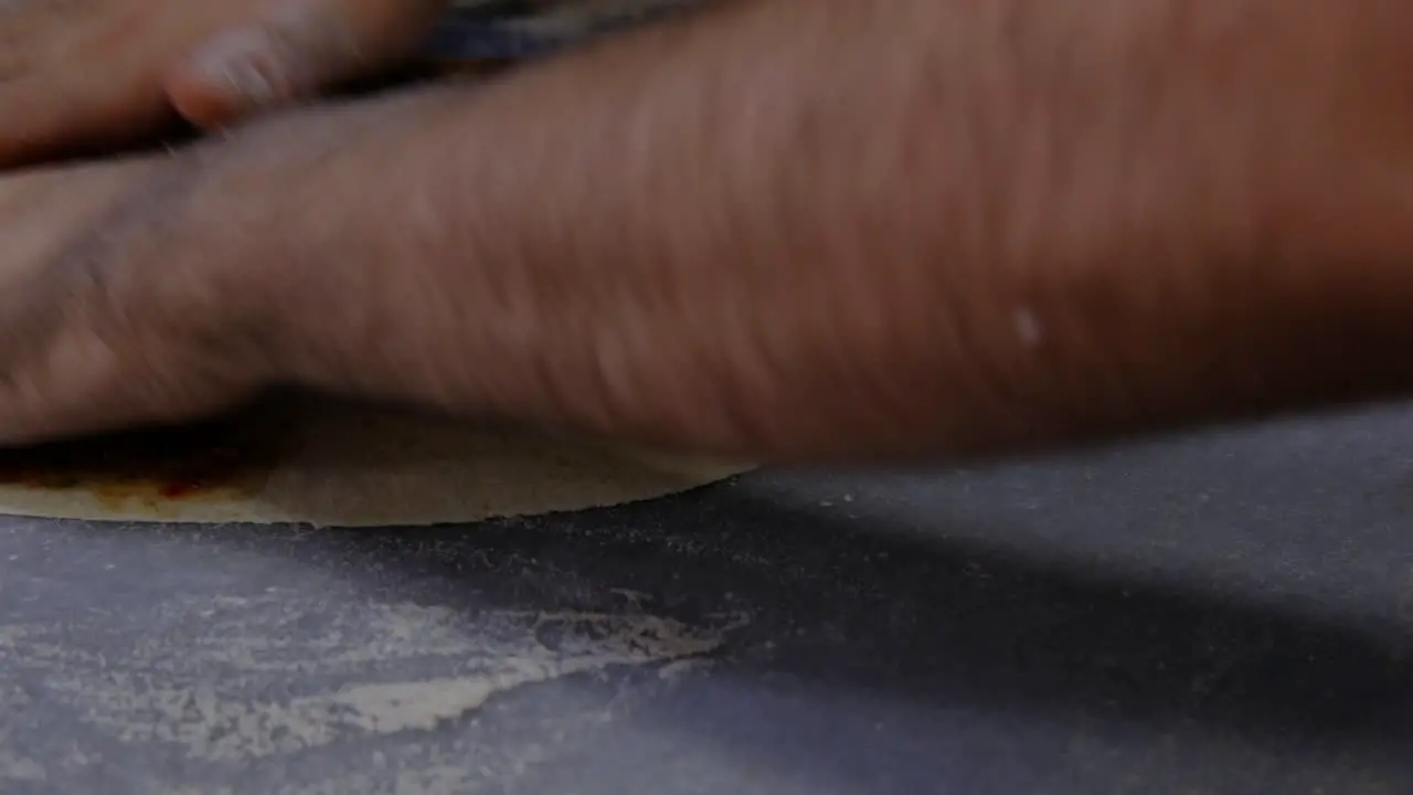 Hands preparing lahmacun