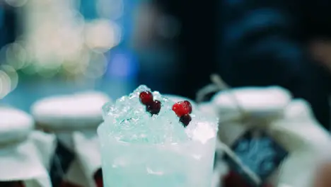 Refreshing red currant drink with ice in glass Barman making berry cocktail