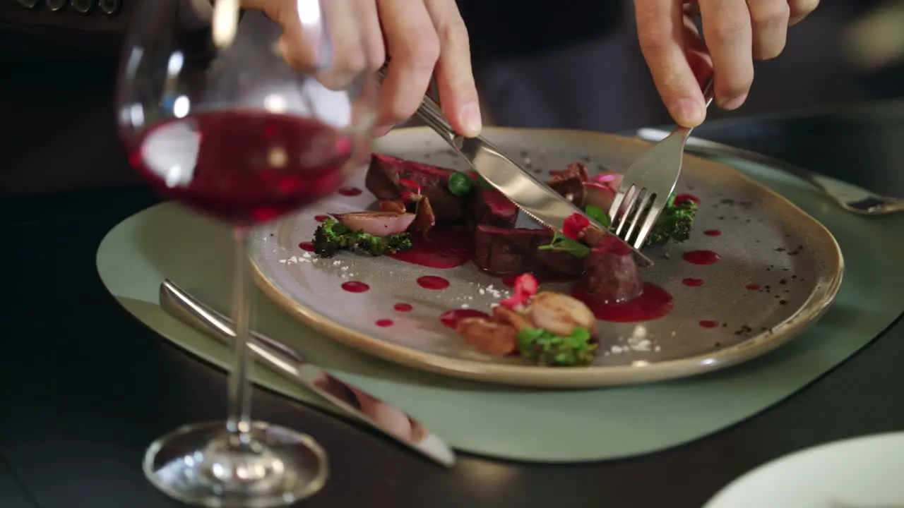 Male hands cutting meat steak at restaurant Business man dining in restaurant