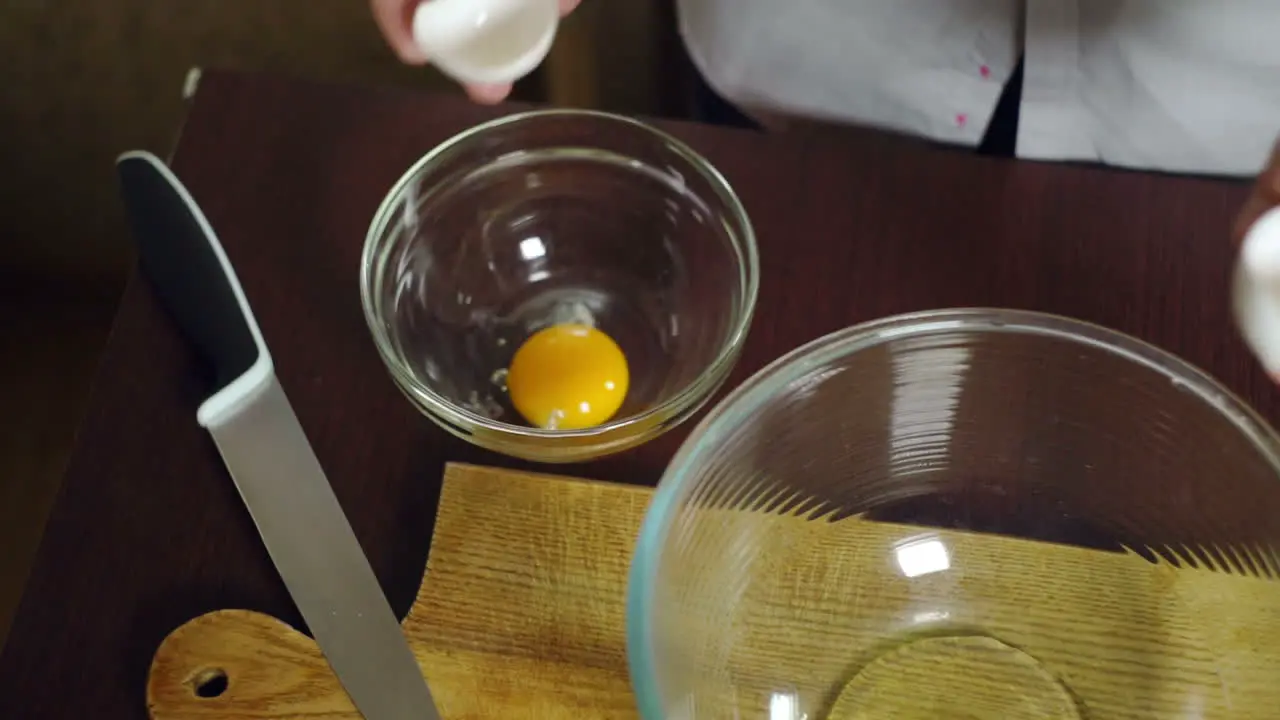 Egg falling in glass bowl Preparing ingredients for baking cake Cooking food