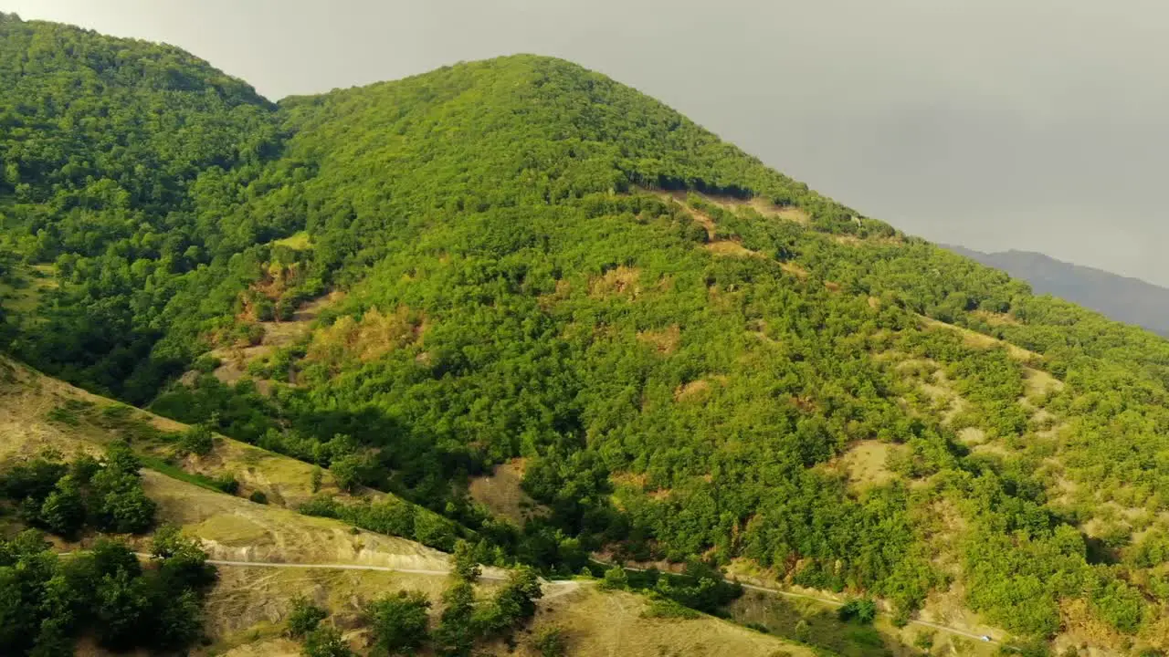 view of green mountains partly sunny partly cloudy