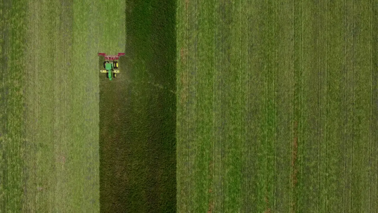 Drone shot of Tractor Mowing the tall grass from up above