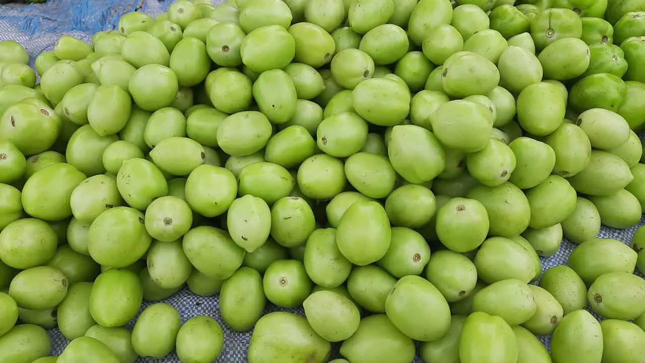 A lot of green tomatoes in the market