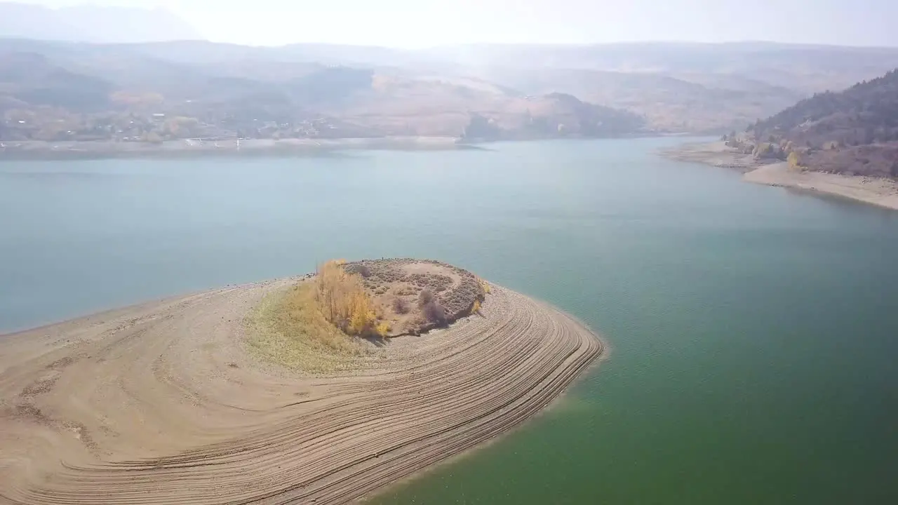 Green Mountain Reservoir Island aerial trucking pan showing dry lake bed with smoky mountain background