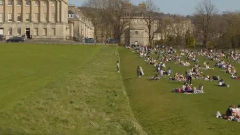 Wide Shot of Large Number of Pedestrians On Royal Crescent Green