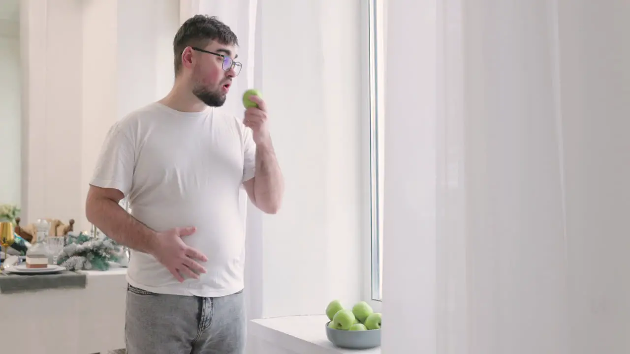 Boy Picking An Apple From A Fruit Bowl And Then He Eats It