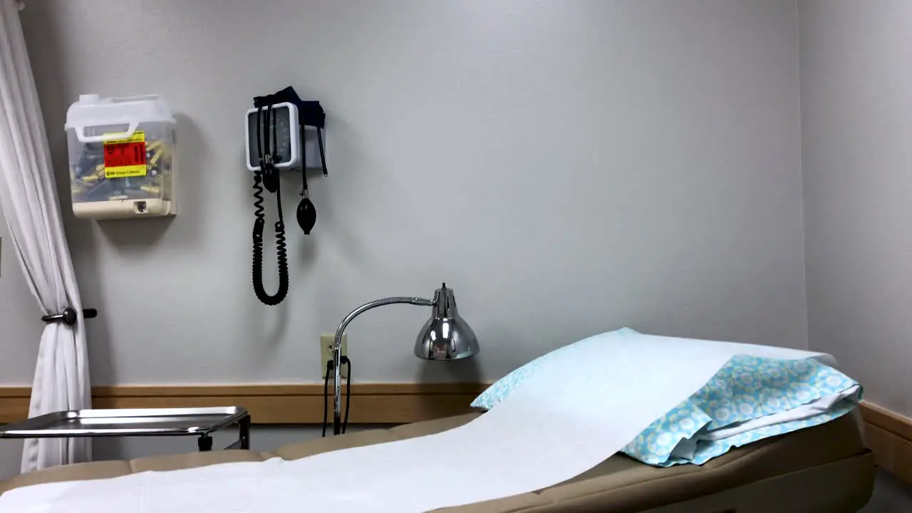 Doctors Office With An Examination Bed And A Wall Mounted Medical Tools