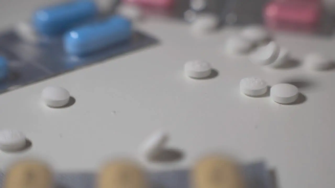 White Pills Drop And Scattered On A White Table