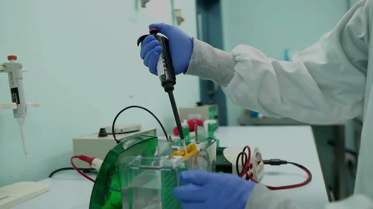 Scientist Using Pipette To Place Samples In Electrolysis Analyser