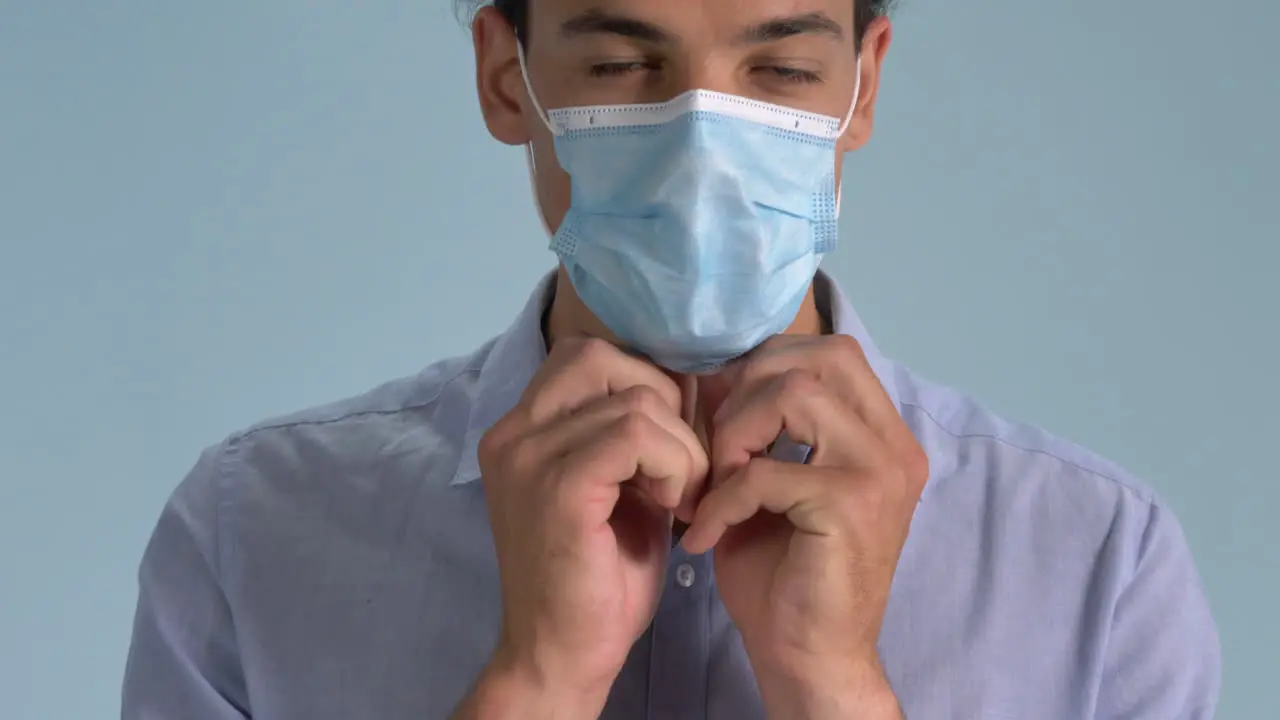 A Professional Looking Man Wearing His Surgical Face Mask Properly Standing On Blue Background Coronavirus Outbreak Closeup Shot