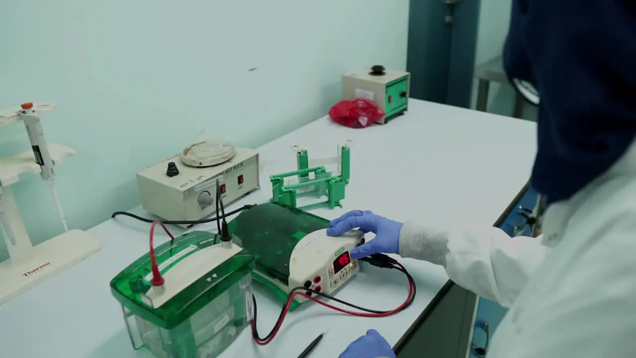 Female Scientist Using Equipment for Electrolysis Analysis