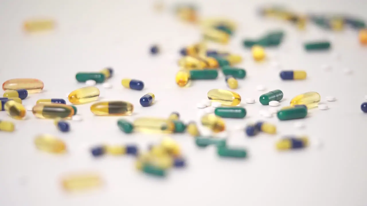 Macro Rack Focus of Pill Varieties Strewn on White Background