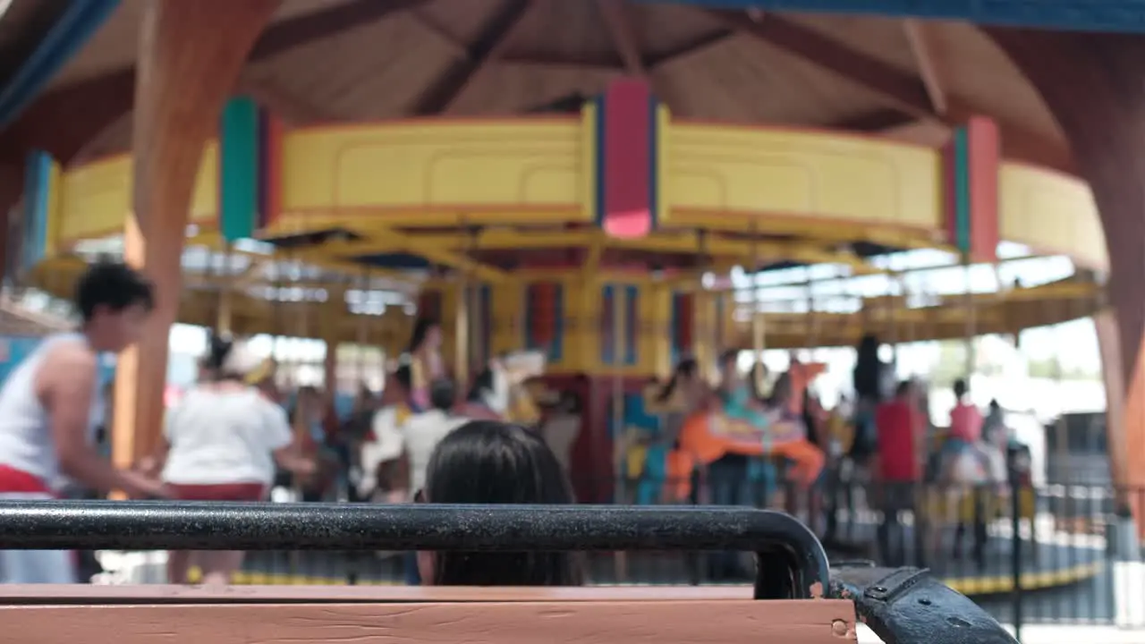 Carosouel spinning with person in foreground