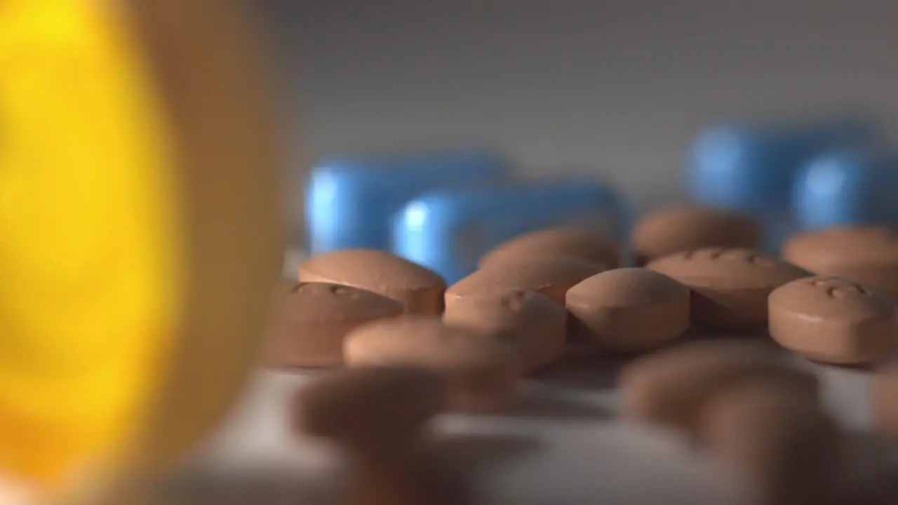 Handful Of Brown Pills On Top Of A White Table With Blurry Background Closeup Shot