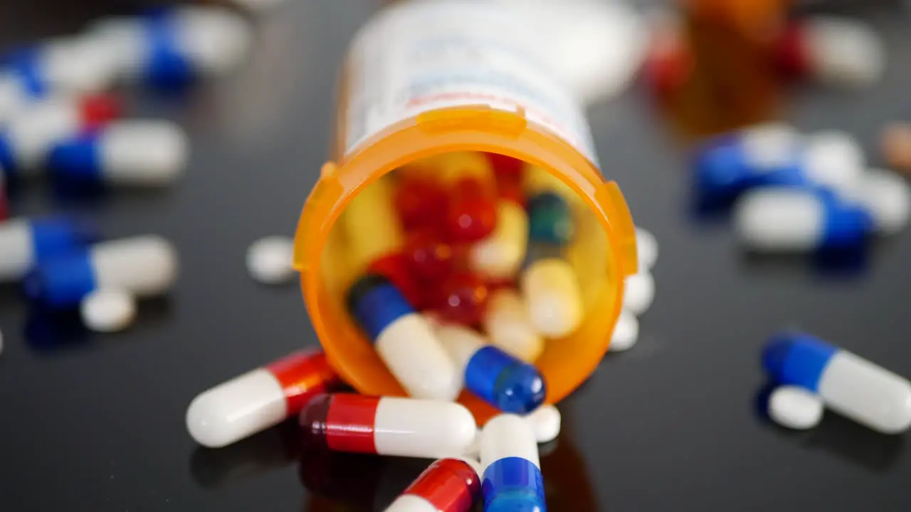 A CVS Pharmacy Drugstore prescription pill bottle with many medicine capsules and drugs