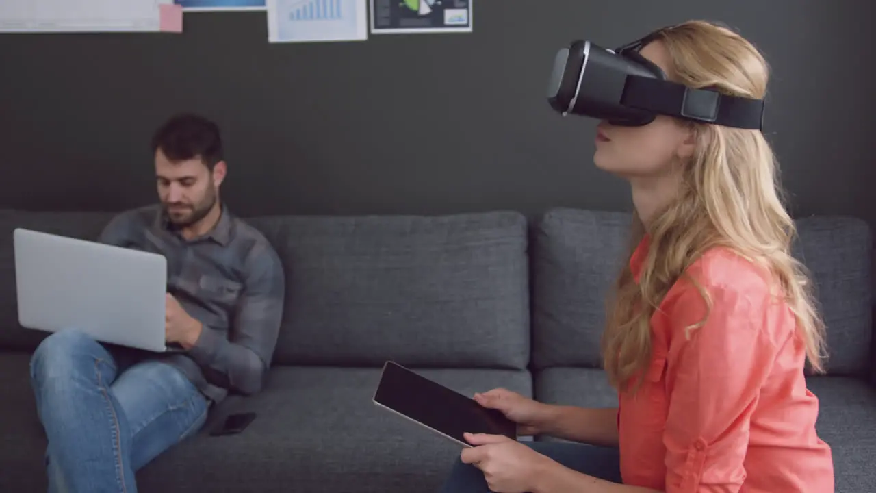 Female executive using digital tablet and virtual reality headset in office 4k