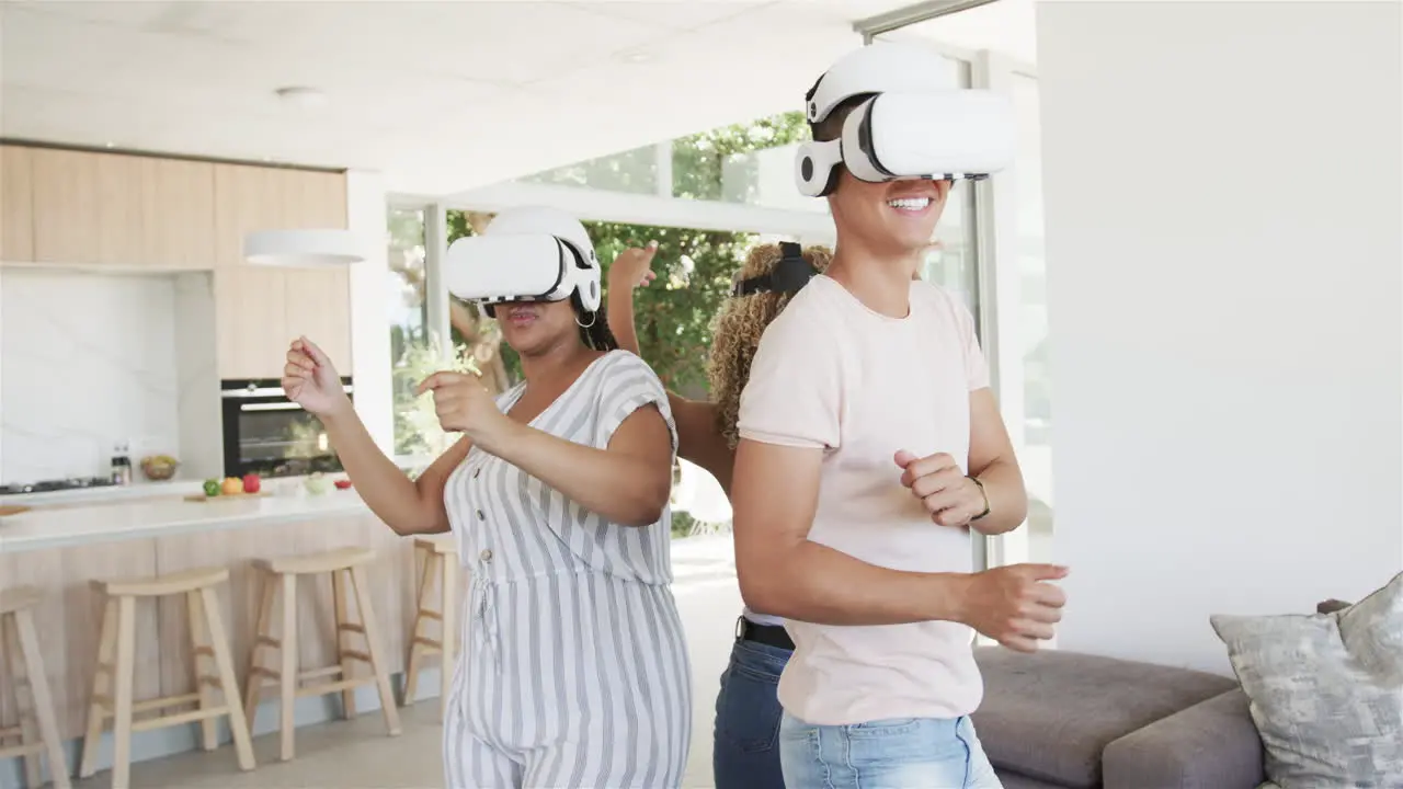 Young biracial women enjoy virtual reality at home