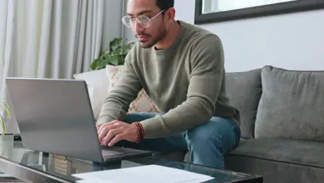 Man glasses and laptop working on sofa