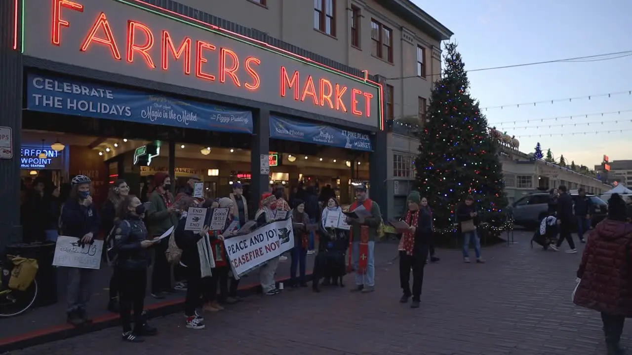 Protestors sing carols in front of pikes market