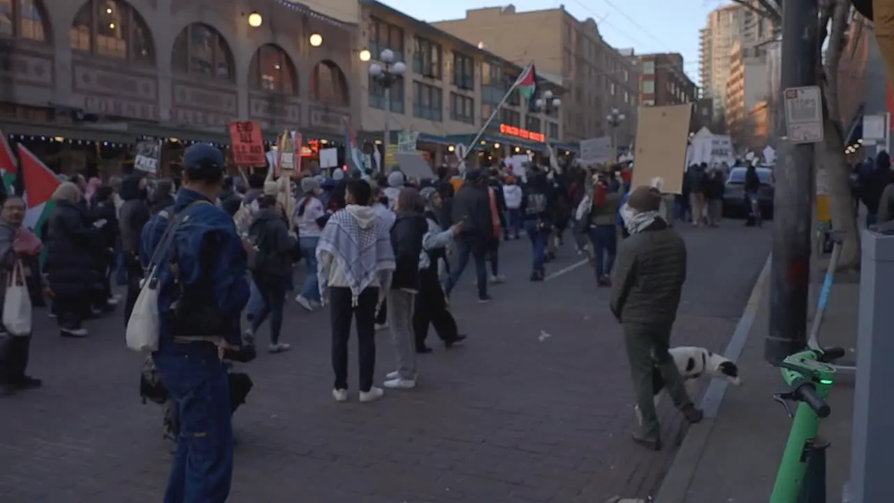 Protestors march while photographer takes picturs