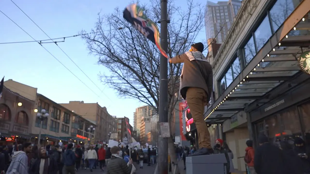 man waving flag at free palastine protest