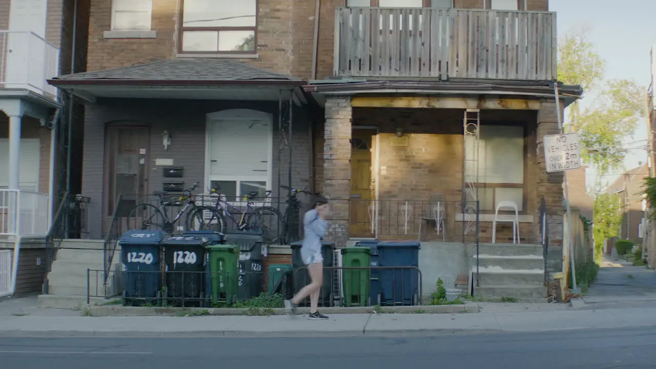 Girl walking out of house