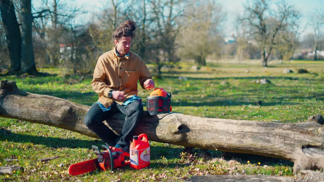 Man handling a chainsaw in the forest before gong to work