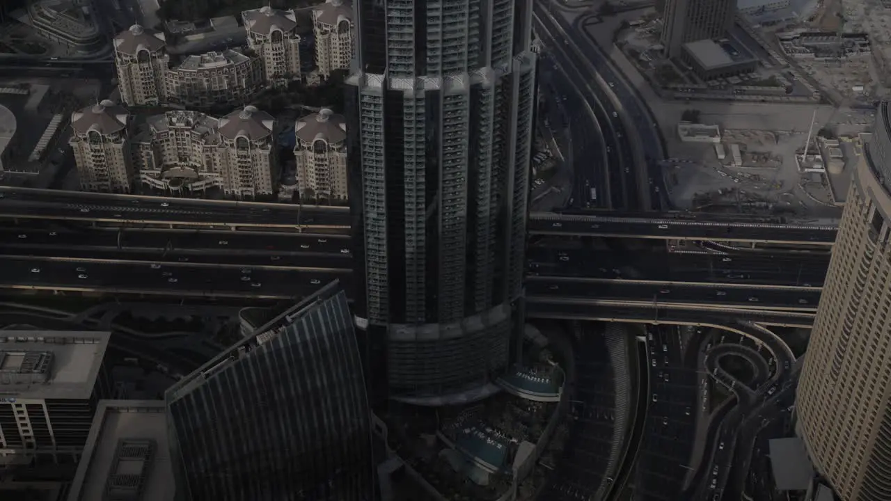 A busy highway with man y cars driving in slow motion surrounded by tall buildings and skyscrapers in Dubai