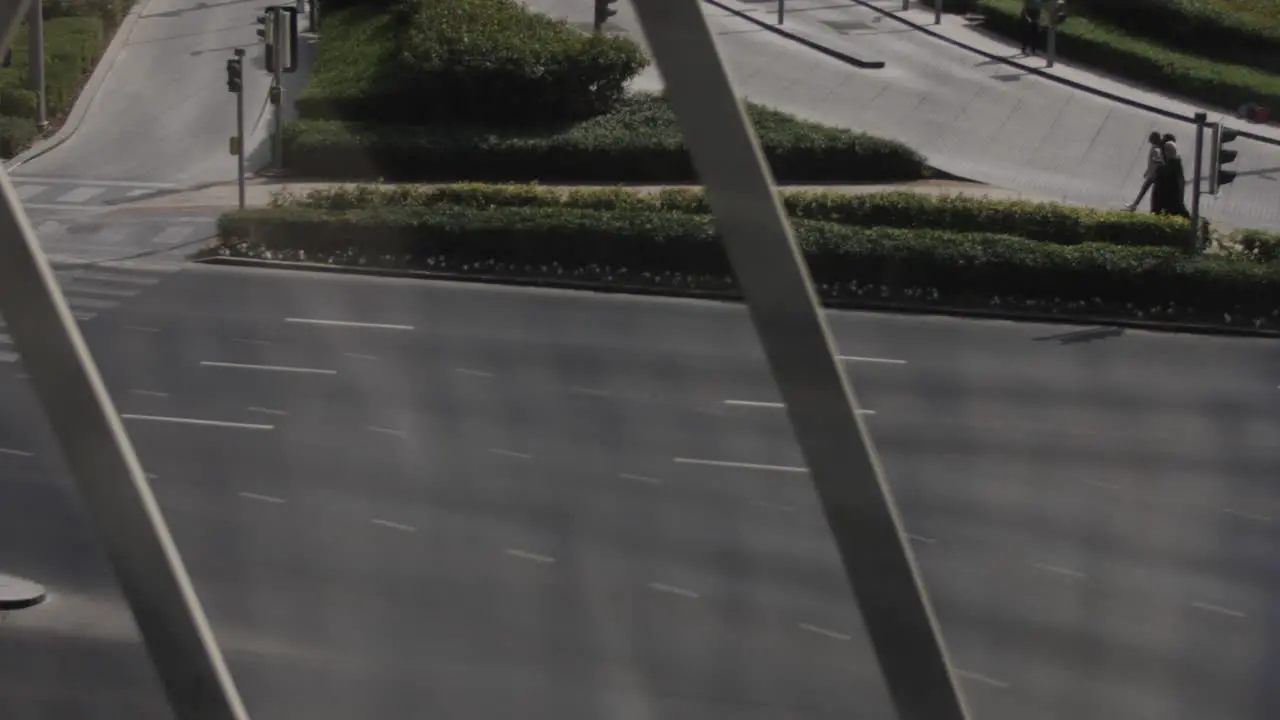 Looking through a window of distant middle eastern woman walking together in downtown Dubai during a sunny day