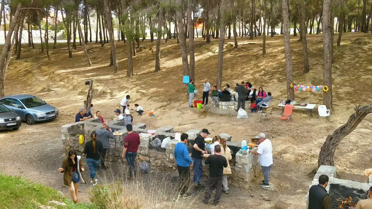 Group of People and Relaxing Spanish Barbecue Outside Weekend Event