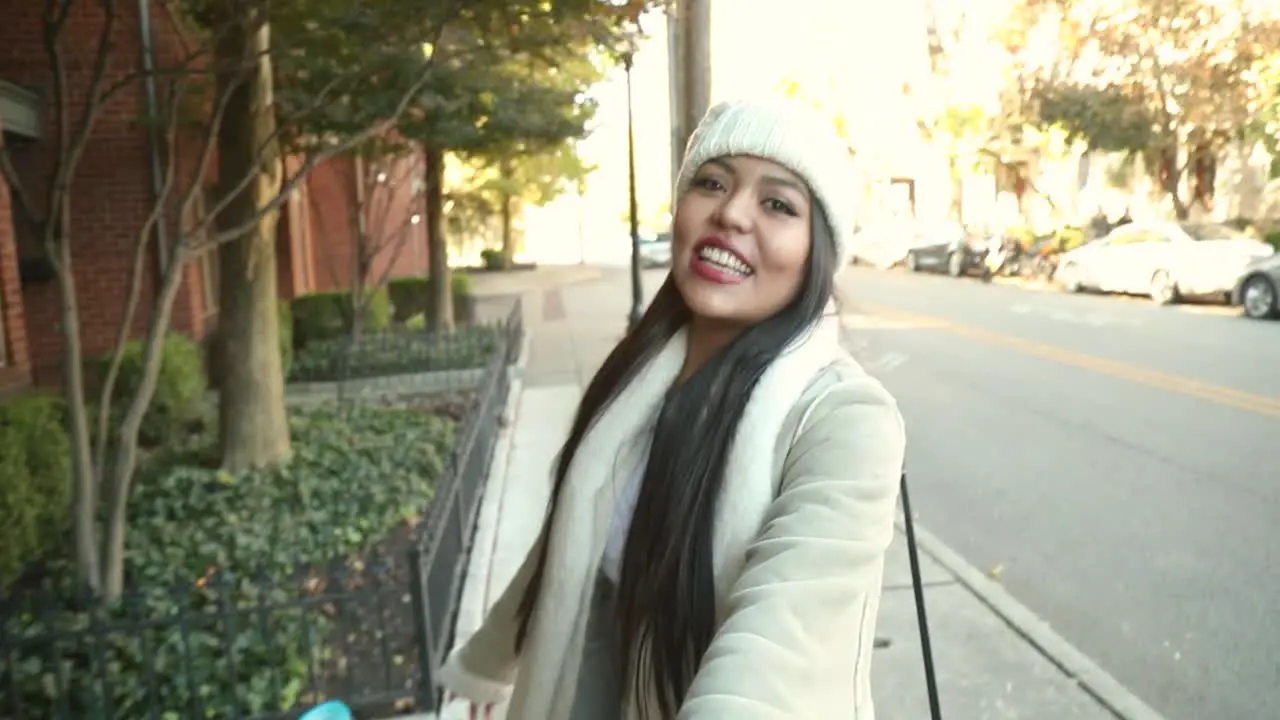 Beautiful girl takes boyfriend's hand and leads the way excited and laughing