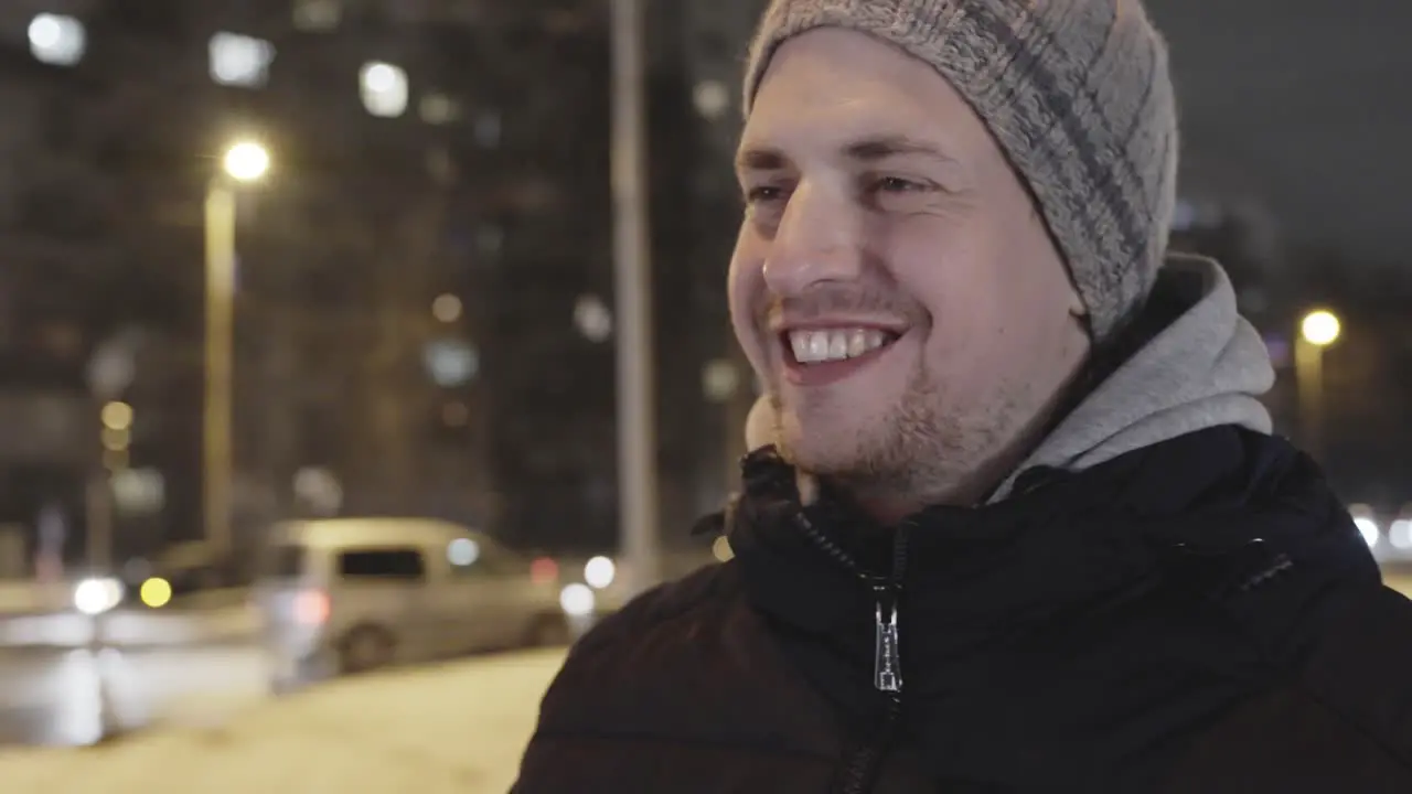 Wide smile on face of happy traveler on a cold winter evening outdoors