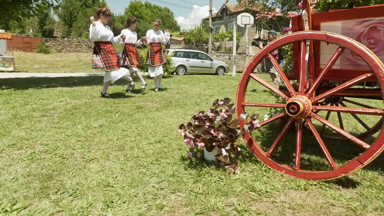 Bulgarian dancing girls filmed performing lively horo at summer festival