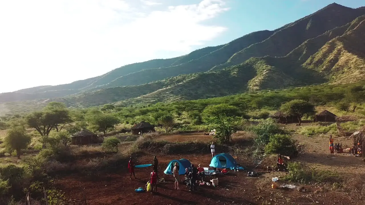 Orbital drone view of a group of outsiders and natives camping at Lake Natron Tanzania East Africa