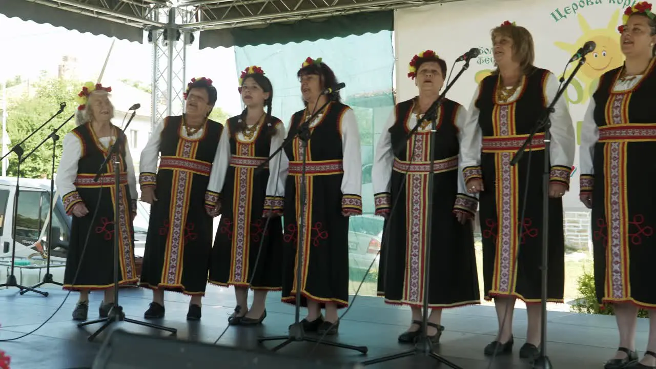 Ladies folk choir sing perform on stage at traditional summer event