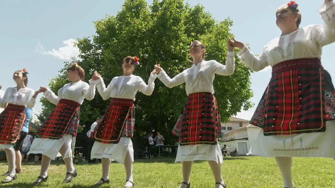 Low camera angle of Bulgarian folk dancers performing traditional horo