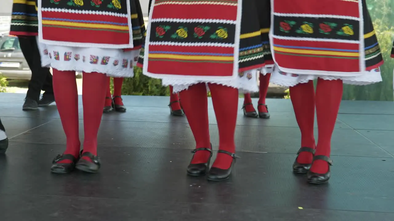 Leg movement of Traditional folk group dancing at cultural event close up