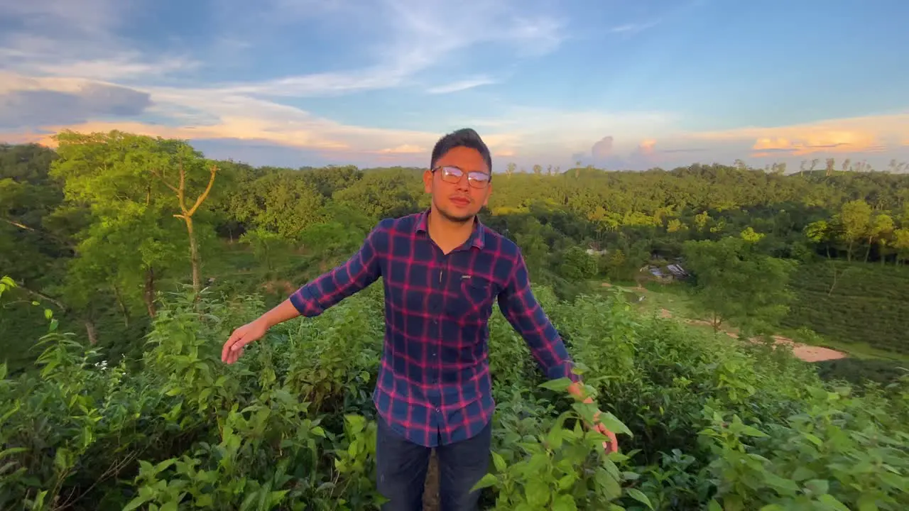 Young adventure traveler exploring nature at hill top in morning sunlight