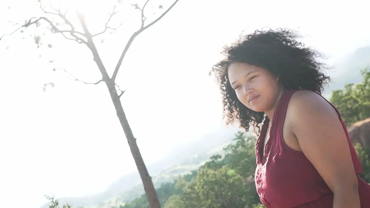 Black girl smiling at the camera while standing on top of a canyon in Thailand