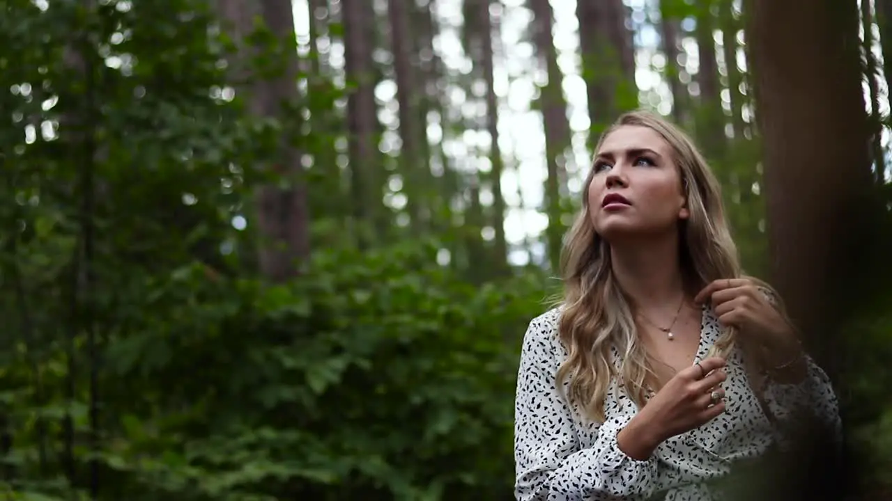 Beautiful young women in awe at the beauty surrounding her in a pine forest in the countryside of Canada