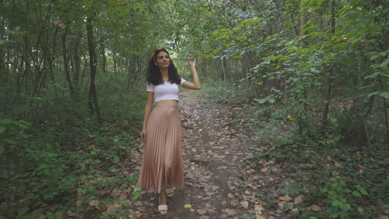 Elegant Young Lady Woman Walking Alone in Nature Forest Park Dolly Tracking Outside Shot of Slim Attractive Girl Relaxing in Nature Casual Trendy Fashion Brunette Stylish Model