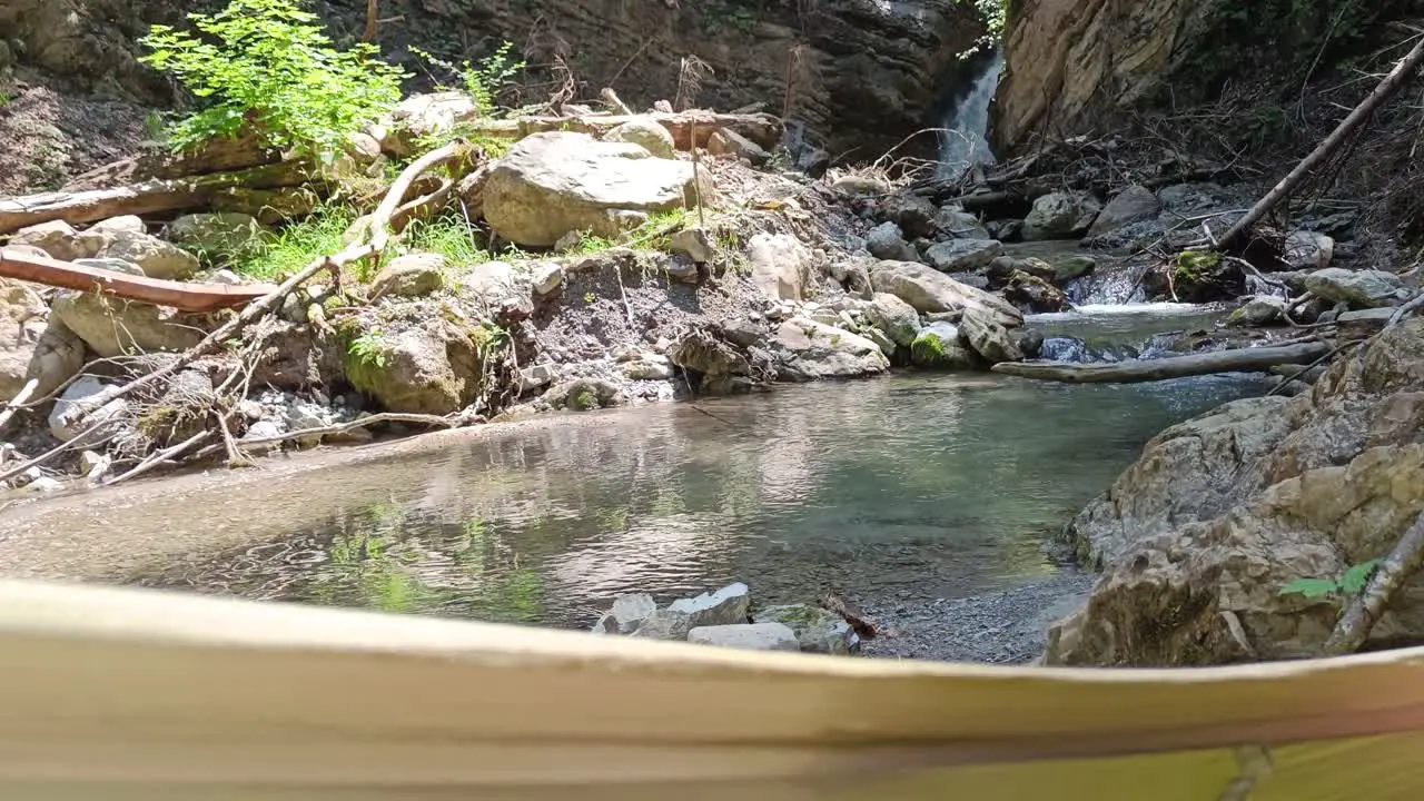 POV view from guy laying in hammock next to beautiful river and waterfall