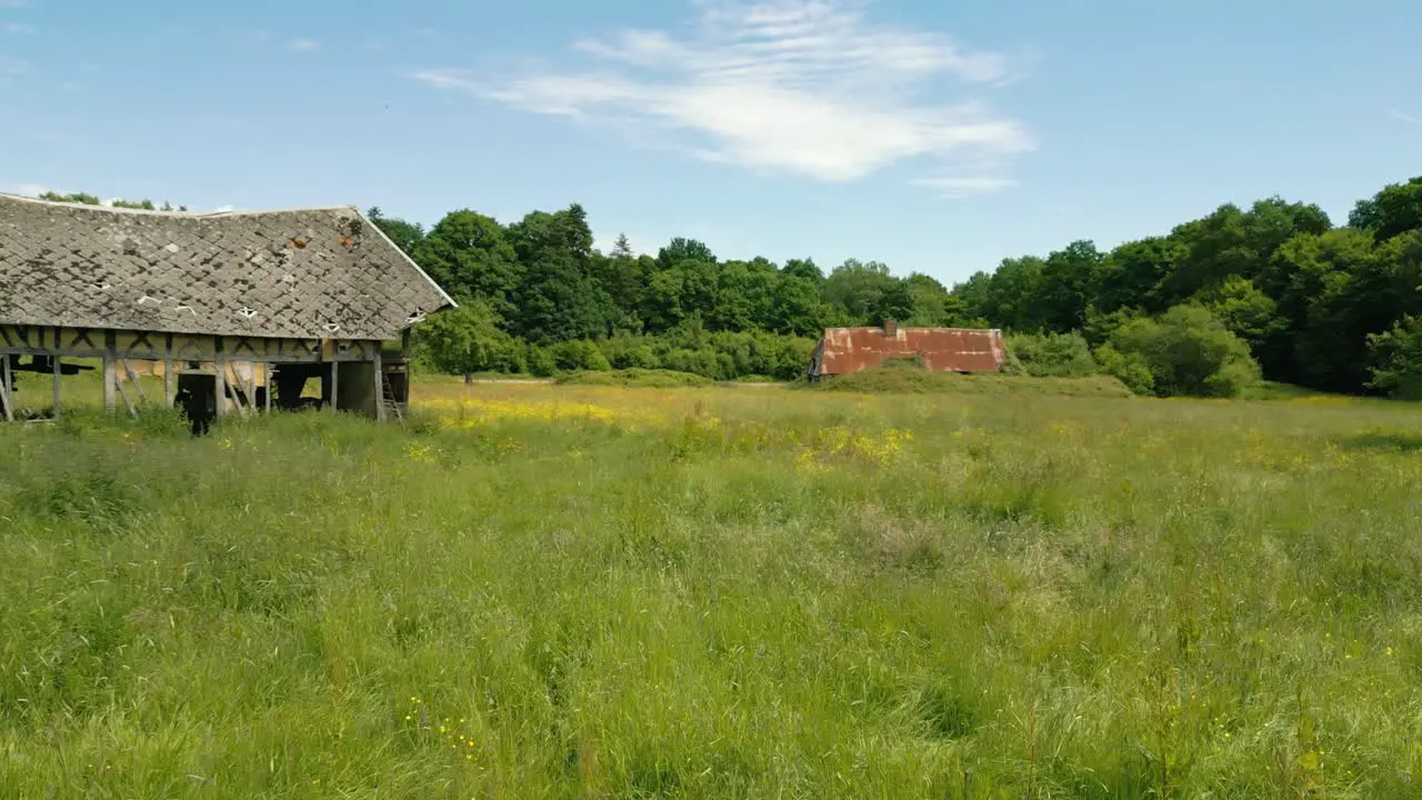 4K Cinematic nature footage of a drone flying over a forest in the middle of the French countryside in Normandy France on a sunny day